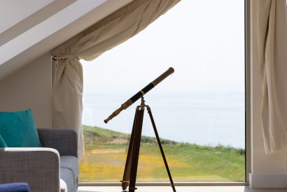 A telescope in the master bedroom which overlooks the sea at Minack View, Cornwall