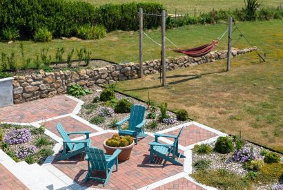 The garden and patio with deck chairs and a hammock at Minack View, Cornwall