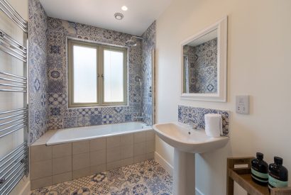 A bathroom with mosaic tiles at Minack View, Cornwall