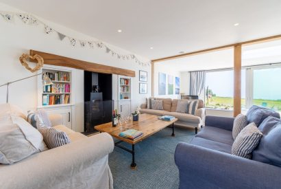 The living room with a log burner at Minack View, Cornwall