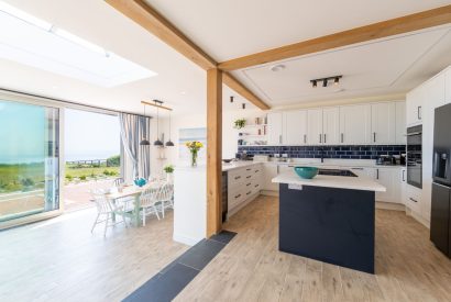An open-plan kitchen and dining room with a sea view at Minack View, Cornwall