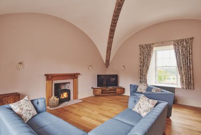 The living room with a log burner at The Tower, Scottish Borders