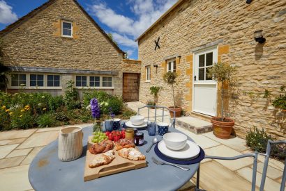 Breakfast in the courtyard at Haymaker Barn, Cotswolds