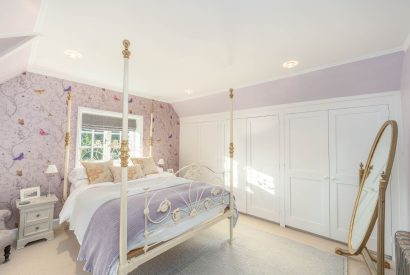 A bedroom with four poster bed at Rose Cottage, Isle of Wight
