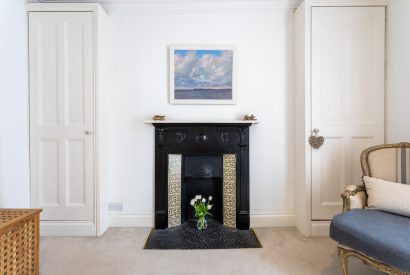 A bedroom fireplace at Cawsand Coastal Retreat, Cornwall