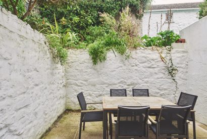 The courtyard with dining table at The New Pin, Cornwall