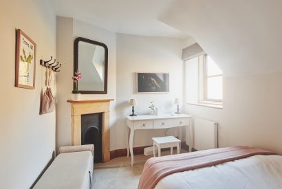 The bedroom fireplace and dressing table at Ember Cottage, Cotswolds