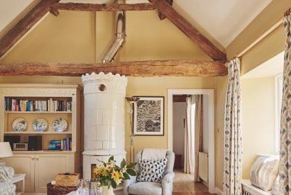 The living room and ceramic wood burner at Milton Cottage, Cotswolds