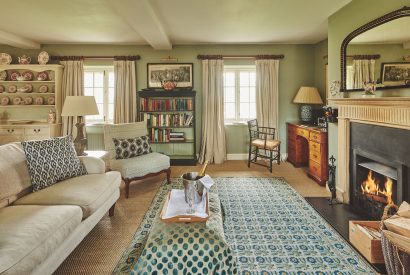 The living room with open fire at Byron Cottage, Cotswolds