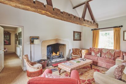 The living room with open fire at Tennyson House, Cotswolds