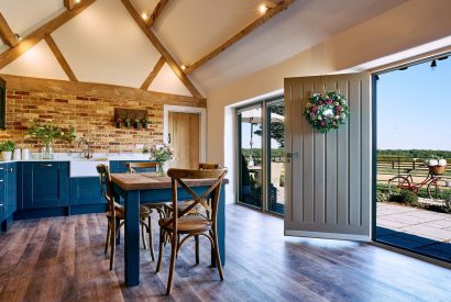 The front door, kitchen and dining table in Stable Barn, Cotswolds