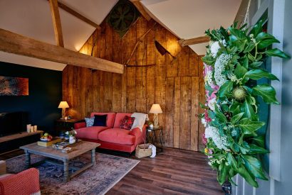 The open-plan living space with the plush velvet sofa in Stable Barn, Cotswolds 