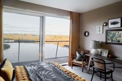 A bedroom with lake view at The Reserve, Cotswolds