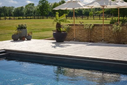The swimming pool and garden at Lakeside Manor, Cotswolds