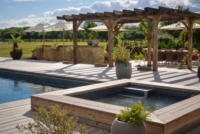 The hot tub and swimming pool at Lakeside Manor, Cotswolds