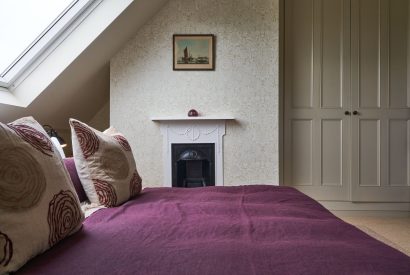 A double bedroom with fireplace at Lakeside Manor, Cotswolds