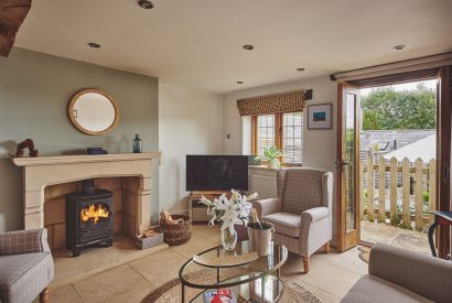 The living room with log burner at Acorn Barn, Cotswolds