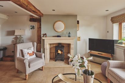 The living room with log burner at Acorn Barn, Cotswolds