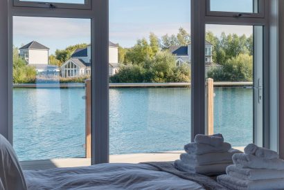 A double bedroom with lake view at Lakefront Lodge, Cotswolds