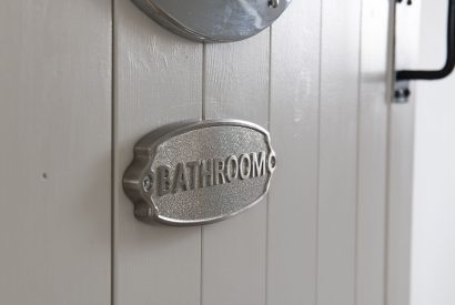 The bathroom door sign at Farmyard Cottage, Wiltshire