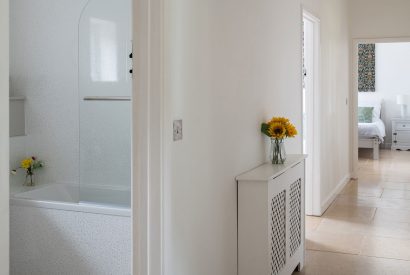 A hallway leading to a bathroom and master bedroom at Farmyard Cottage, Wiltshire