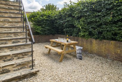 The outdoor courtyard and picnic bench at The Milking Parlour, Wiltshire 