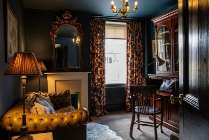 A formal sitting room with a writing desk at The Townhouse Sherborne, Dorset