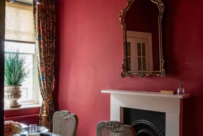 The formal dining room with an original fireplace at The Townhouse Sherborne, Dorset