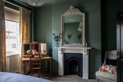 A double bedroom with an original fireplace at The Townhouse Sherborne, Dorset