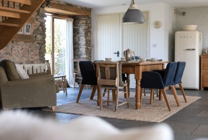 The dining table with French doors onto the patio at Chapel Cottage, Pembrokeshire