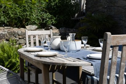 An outdoor dining table in the garden at Chapel Cottage, Pembrokeshire