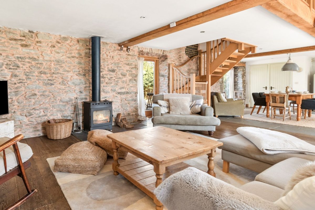 The open-plan living room with a log burner at Chapel Cottage, Pembrokeshire