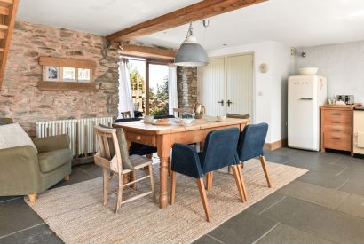 The dining room with doors onto the patio at Chapel Cottage, Pembrokeshire
