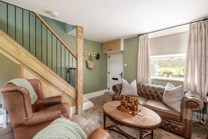 The living room with a sofa and two armchairs around a coffee table at High Moor Cottage, Yorkshire