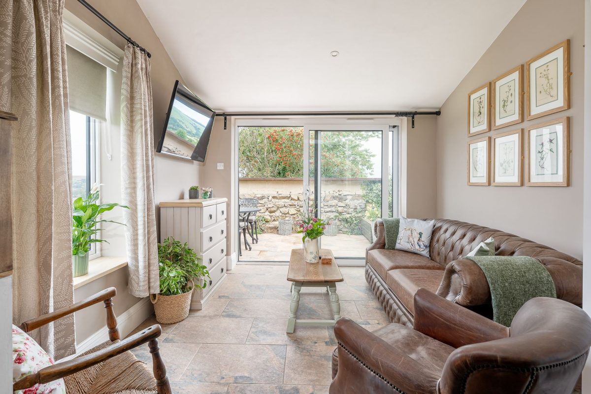 The garden room with doors leading on to the patio at High Moor Cottage, Yorkshire