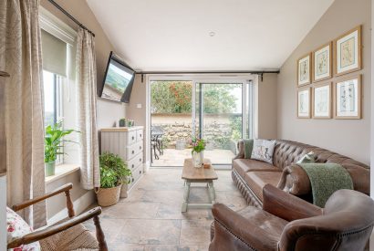 The garden room with doors leading on to the patio at High Moor Cottage, Yorkshire