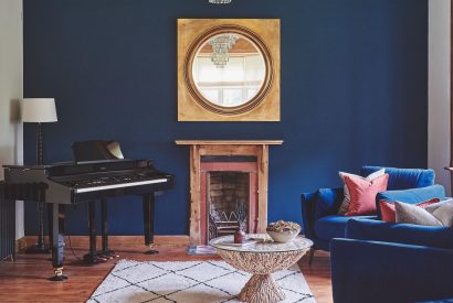 The living room with a grand piano at The Old Vicarage, Lake District