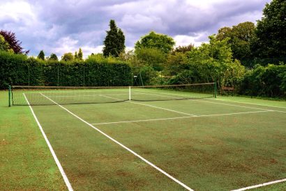 The tennis court at Hawkins Loft, Kingham, Cotaswolds