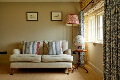 A sofa in the living room at Orchard Stable, Cotswolds