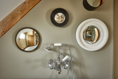 Mirrors on the wall in the bathroom at Orchard Stable, Cotswolds