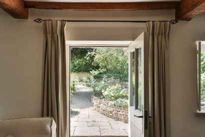 The front door with views to the stone pathway at Rambling Rose Cottage, Cotswolds