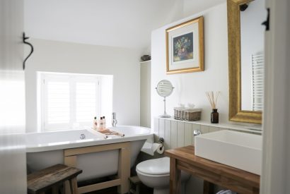 The bathroom with a free standing bath at Rambling Rose Cottage, Cotswolds
