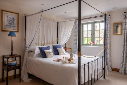 A four poster bed at Cotswold Retreat, Cotswolds