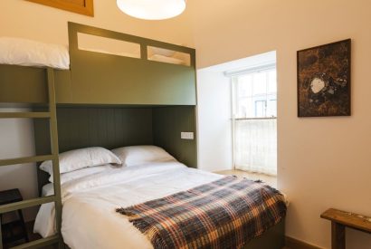 King size bedroom with bunk at Weaver's Cottage, Roundstone, Galway