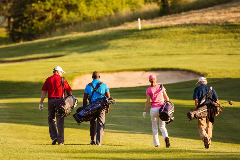 Four people playing golf