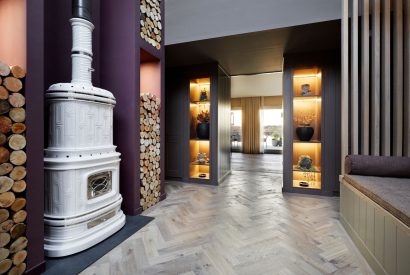 The entrance hall with log burner at The Reserve, Cotswolds