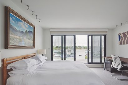 A bedroom with a balcony at The Crewhouse, Hampshire