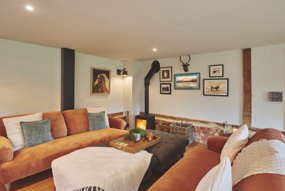 The living room with log burner at The Retreat, Hampshire