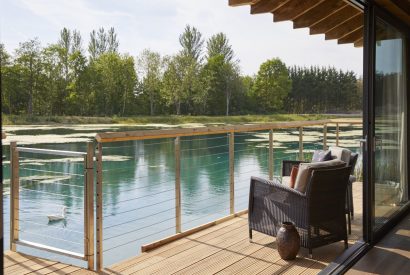 The balcony with lake view at Lakeside Cabin, Cotswolds