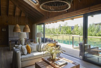 The living space with lake view at Lakeside Cabin, Cotswolds